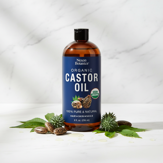 Bottle of Nexon Botanics Organic Castor Oil with leaves and seeds on a white background